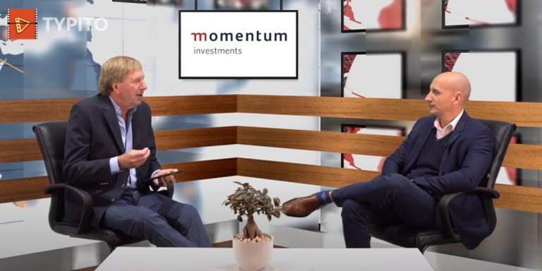 Paul Nixon and Derek Watts seated across each other in an interview.