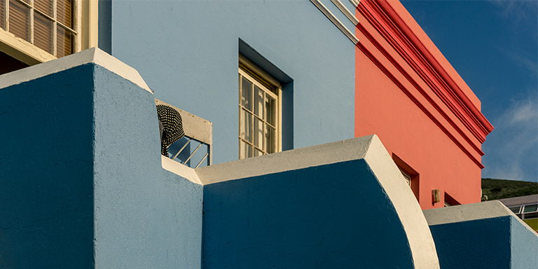 An insured, freshly painted multicoloured building in  pristine condition.