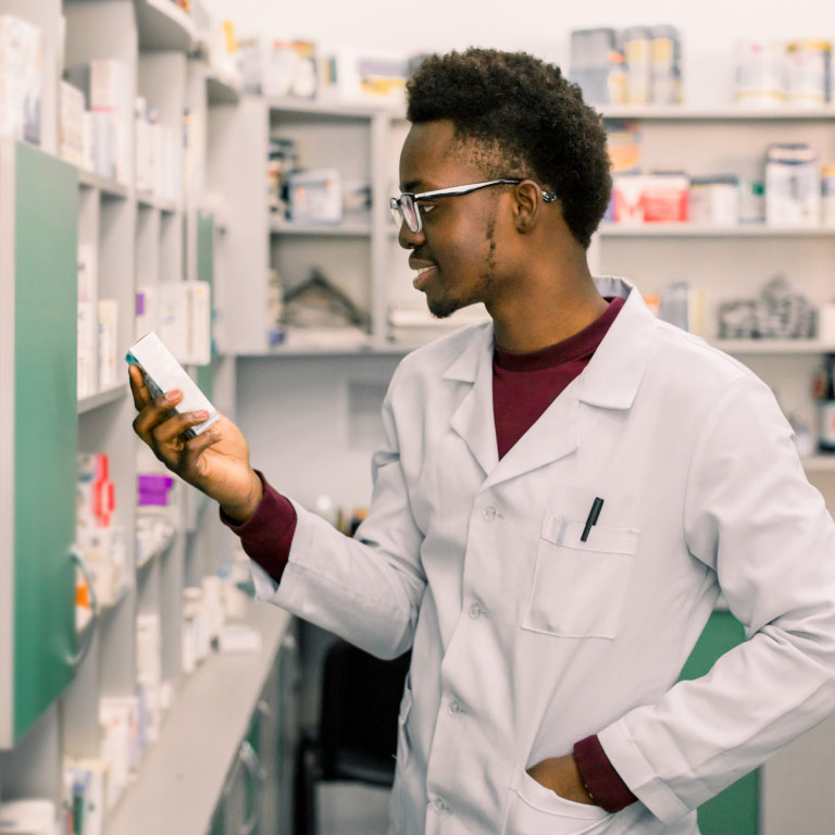 A pharmacist taking out prescription medication for his customer who uses the Chronic Benefit from their medical aid with Momentum.