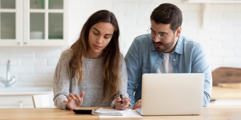 Young married couple calculating the value of their estate to determine the estate cover they need to settle their costs of dying with Momentum’s Estate Provider Benefit.