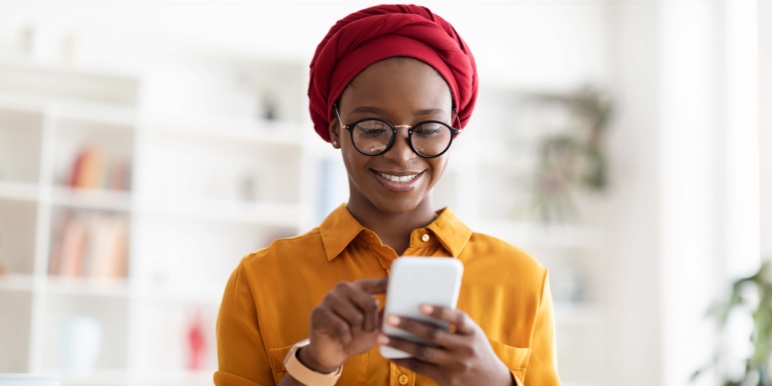 Woman smiling looking at her phone.