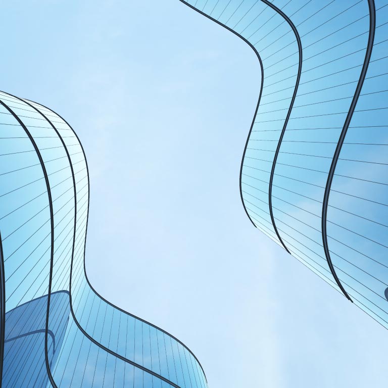 Low-angle view of 2 curved glass buildings reflecting off each other.