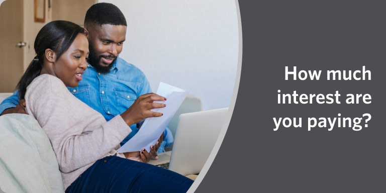 Couple reviewing documents together in a video on understanding interest payments.