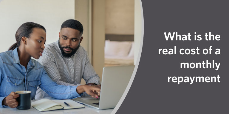 Couple looking at a laptop together in a video about understanding TV repayment costs.