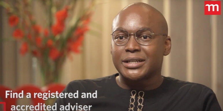 Stanley Gabriel, Momentum Savings CEO in black African print shirt, discusses finding the right financial adviser on Money Heroes podcast.