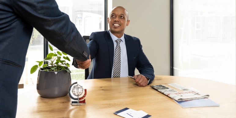 Financial adviser discussing retirement annuity withdrawal and cross-border fund management with a client.