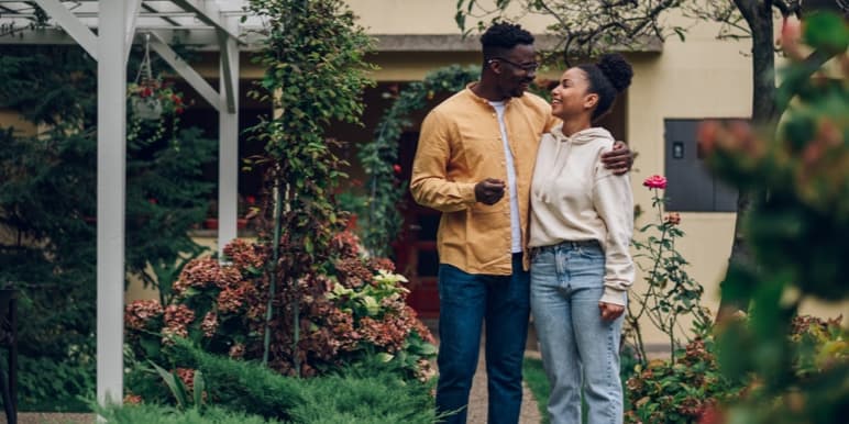 A happy couple taking a walk outdoors.