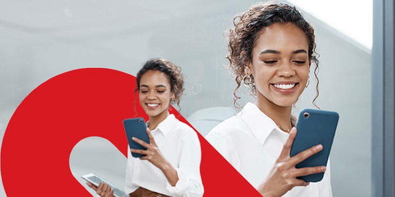 A Momentum Corporate branded image of a young female professional in a crisp white shirt, taking a selfie at the office.