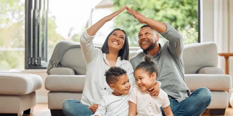 Parents and children smiling at home, showing peace of mind from protecting their legacy with Momentum Estate Plan.