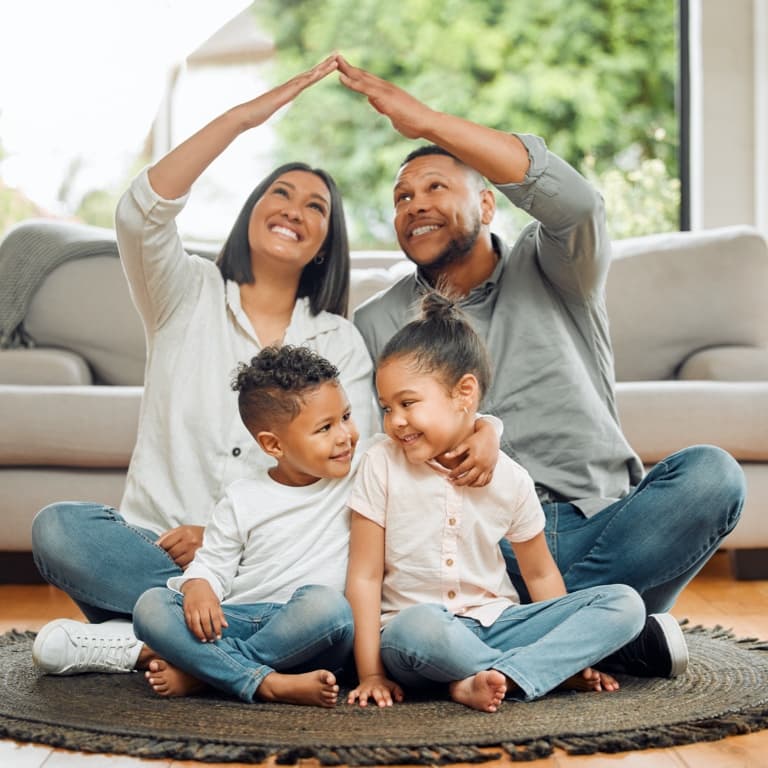 Parents and children smiling at home, showing peace of mind from protecting their legacy with Momentum Estate Plan.