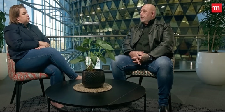 Mandy Wiener in conversation with a guest about digital safety, set in a modern office environment for Momentum Insure's 'Circle of Safety' YouTube series.]