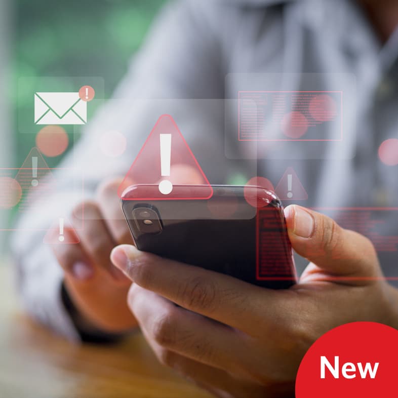 Person’s hands holding a smartphone with digital warning icons and alert symbols, representing cybersecurity and digital safety awareness.