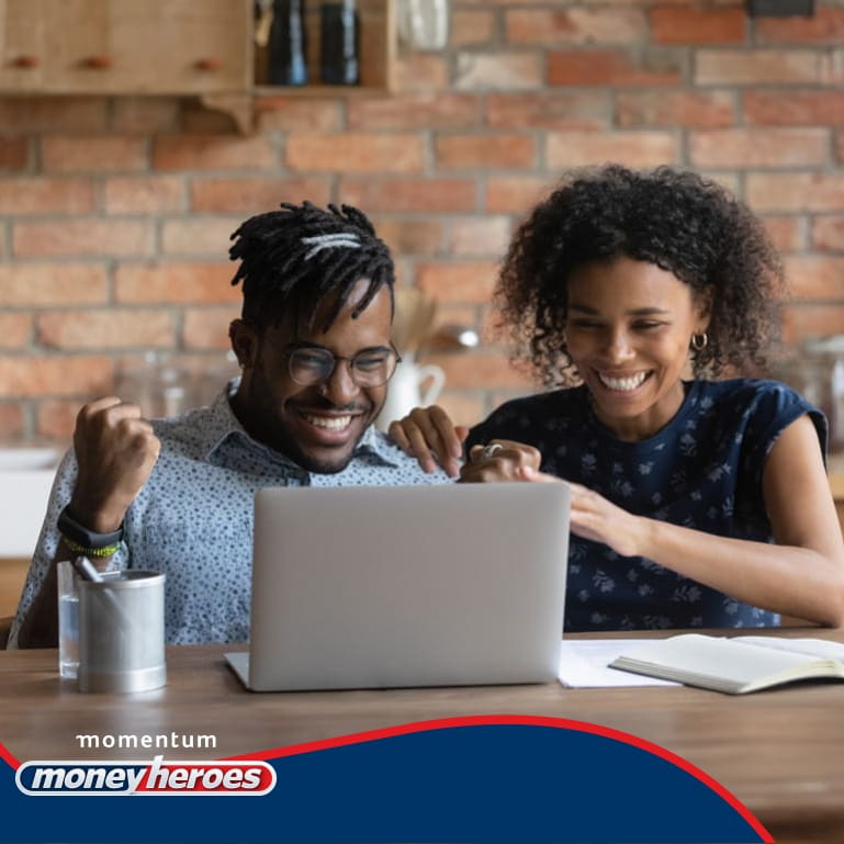A happy young couple watching Money Heroes content on their laptop and feeling energised and inspired by the financial advice.