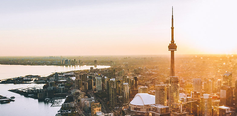 An aerial view of downtown Toronto and it's coastline at dusk.