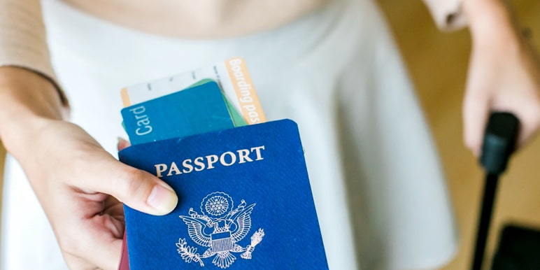 A hand holding a passport.

