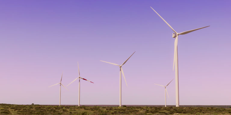 Wind turbines in the middle of the ocean.