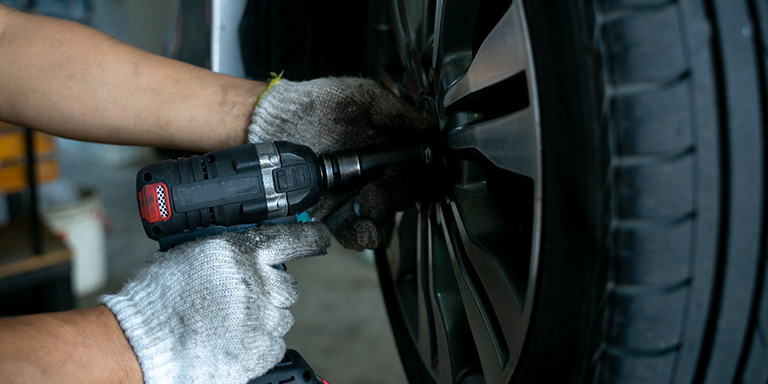 A car tyre being worked by a mechanic who's wearing gloves. Tyre cover is an optional benefit with Momentum Insure. It covers for loss or damage to tyres fitted to your insured vehicle.