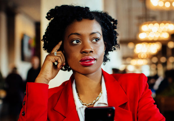 A young female professional thinking about her finances.