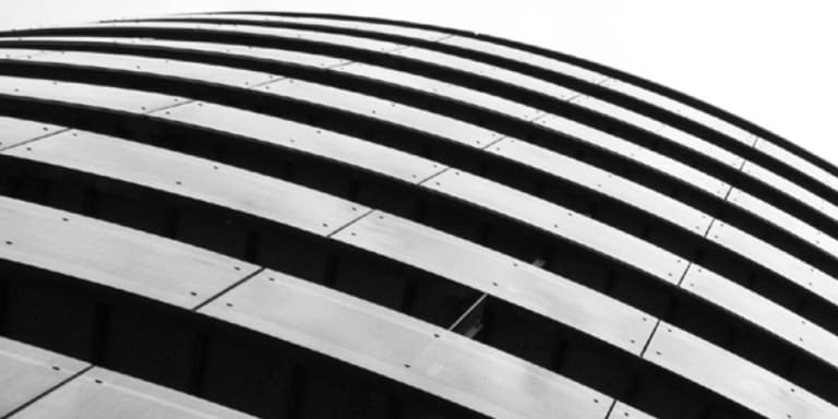 A round multi-story, concrete office building.