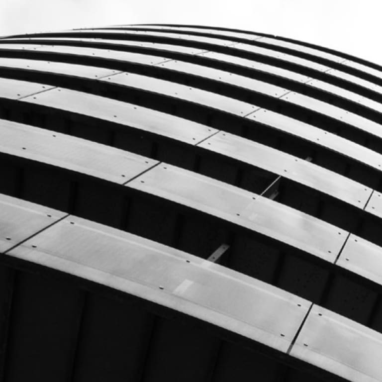 A round multi-story, concrete office building.