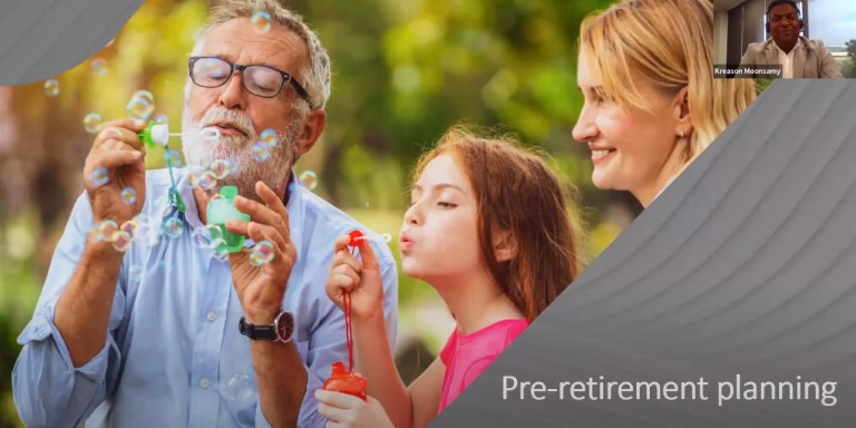 Grandparents and their granddaughter share a joyful moment, blowing bubbles together and laughing as they watch them float away.