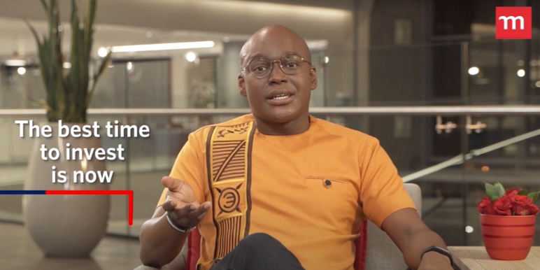 Stanley Gabriel, Momentum Savings CEO in yellow African print shirt, discusses saving and investing to grow wealth on Money Heroes podcast.