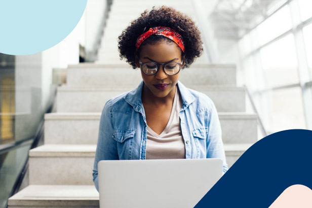 A young woman is updating her life insurance beneficiaries on her laptop.