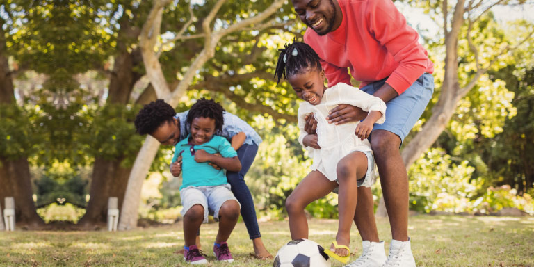 Parents playing with their kids in the park.